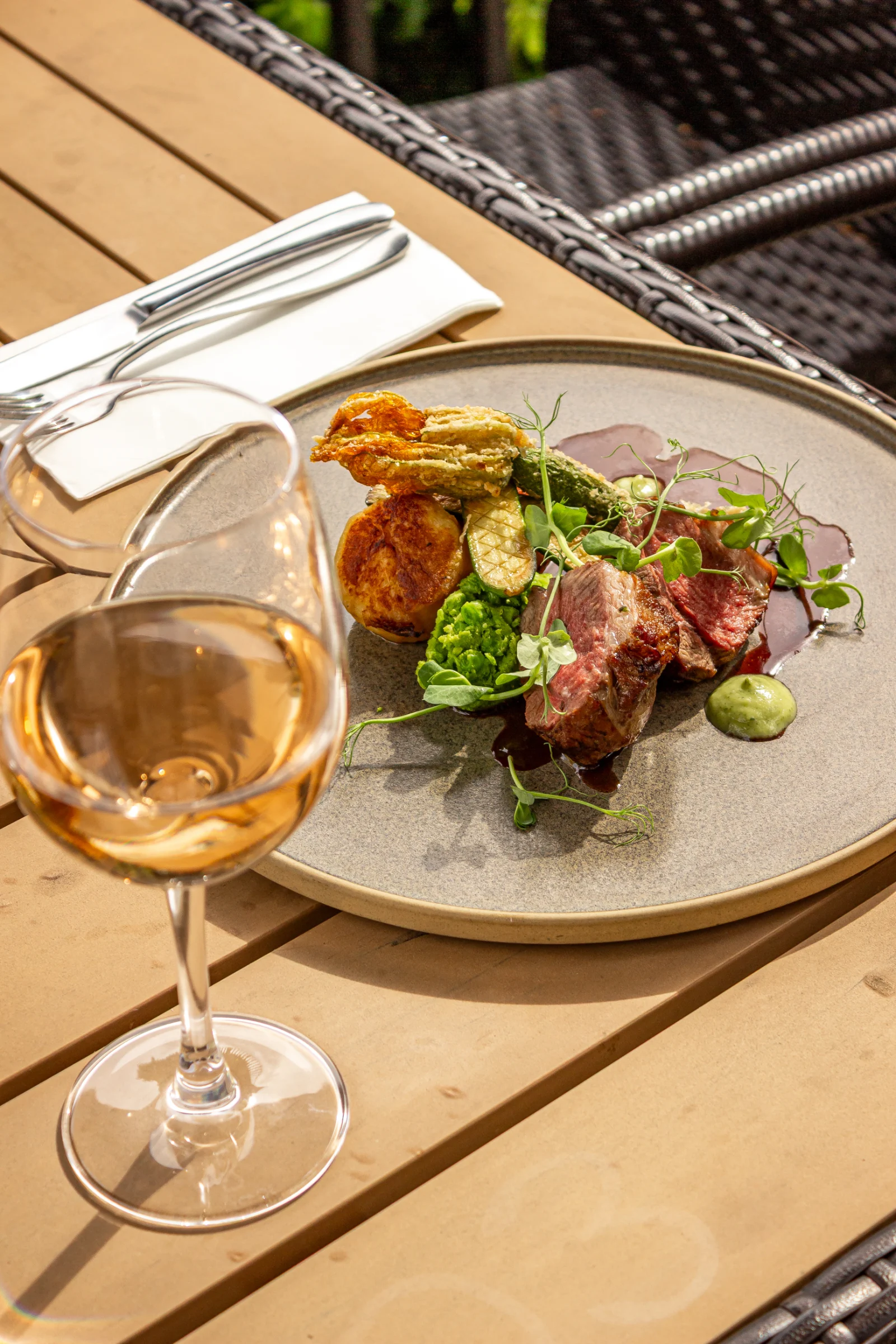 Wine and lamb dish served at the table